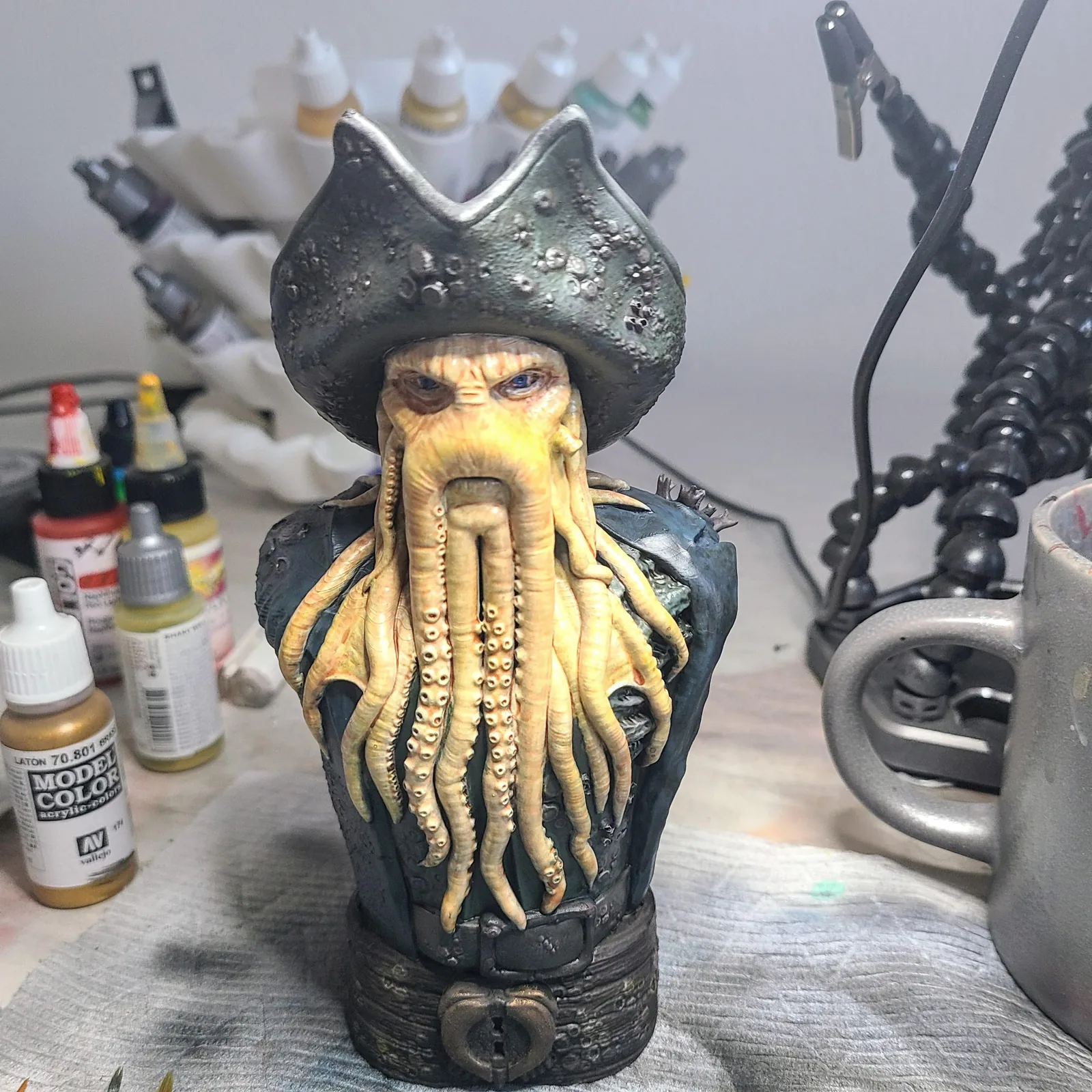 A painted pirate bust with a tentacled beard