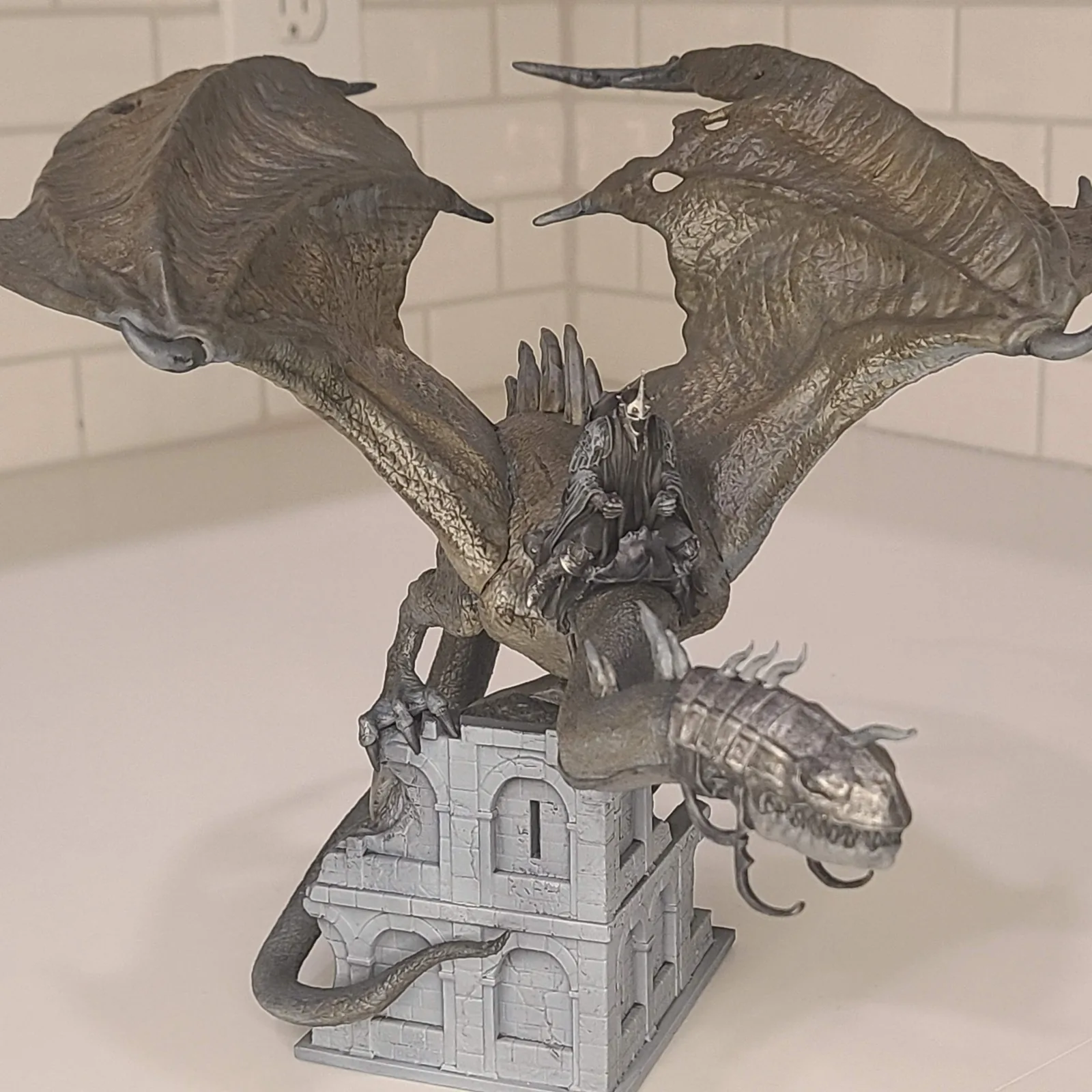 A winged dragon model on a display base