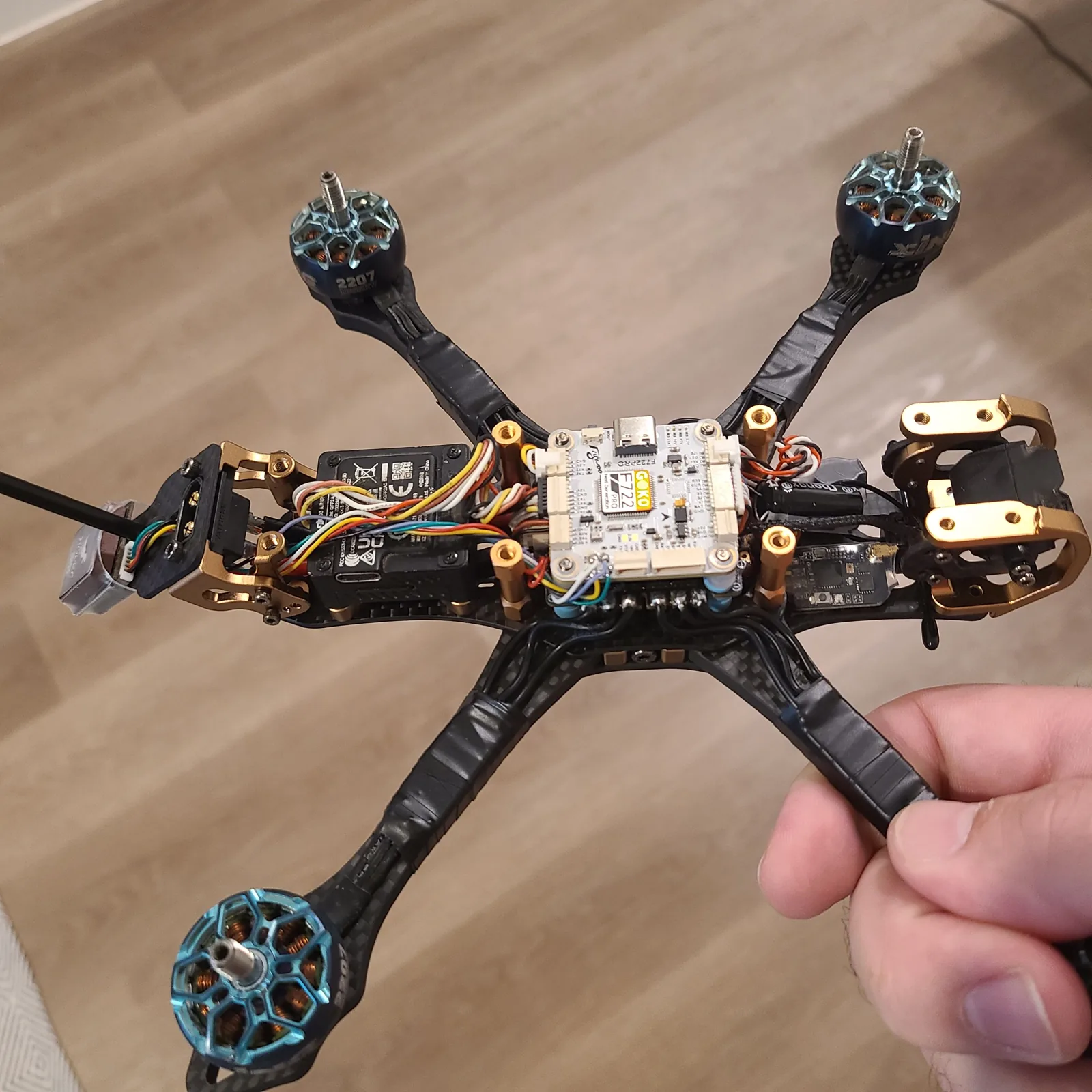 An FPV drone frame with exposed electronics and wiring